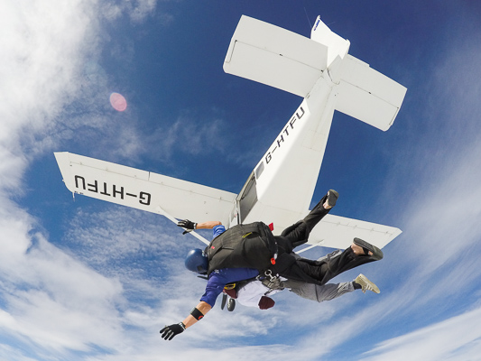 tandem skydivers exiting aircraft